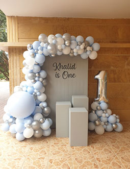 Elegant Grey First Birthday ( Grey backdrop,  Personalisation on backdrop,  3 grey plinths,  Balloon arch &amp; Number foil balloon )