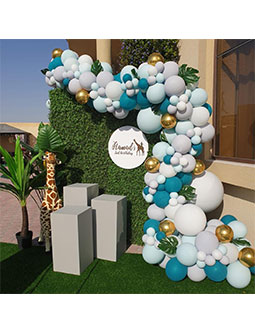 Giraffe Safari ( Green Wall Backdrop 2m x 2m, Personalisation on round signage, Balloon arch, 3 grey plinths, Giraffe prop, Plant prop )