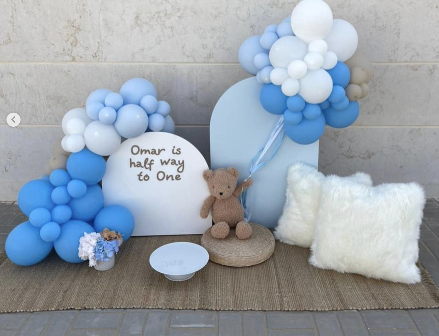 Half way to One with Teddy (Balloon garland 1 x mini Vase Imitation Florals 1 x Carpet and 1 available Teddy for rent 2 x Mini Backdrops (90cm H and 60cm H) Personalization on Backdrop 2 x Available pillows)